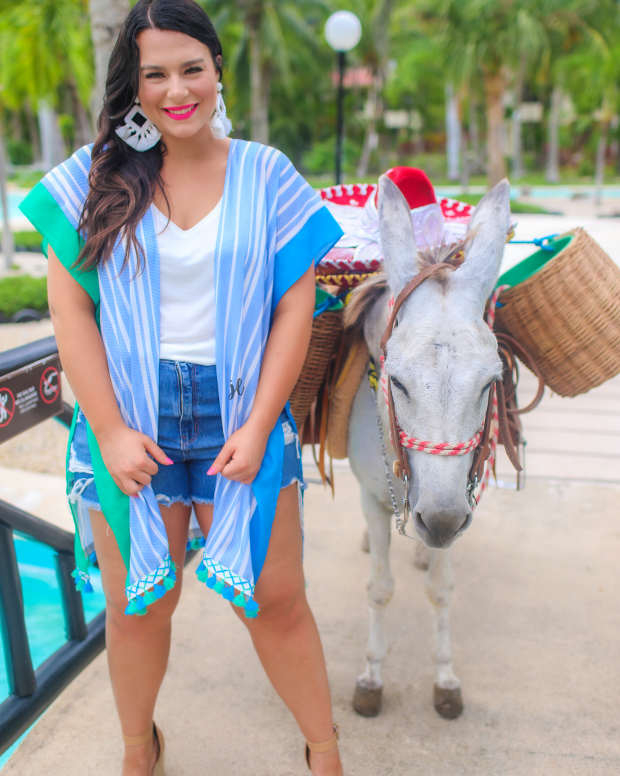 a loose-flowy fit kimono crafted from lightweight fabric with an open-front style, pom pom detailing, colored sides, and contrasting panels