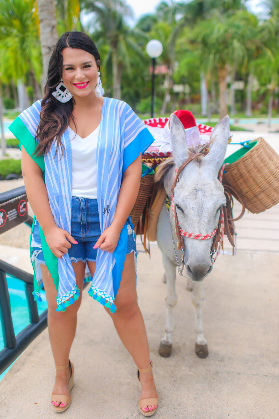 a loose-flowy fit kimono crafted from lightweight fabric with an open-front style, pom pom detailing, colored sides, and contrasting panels