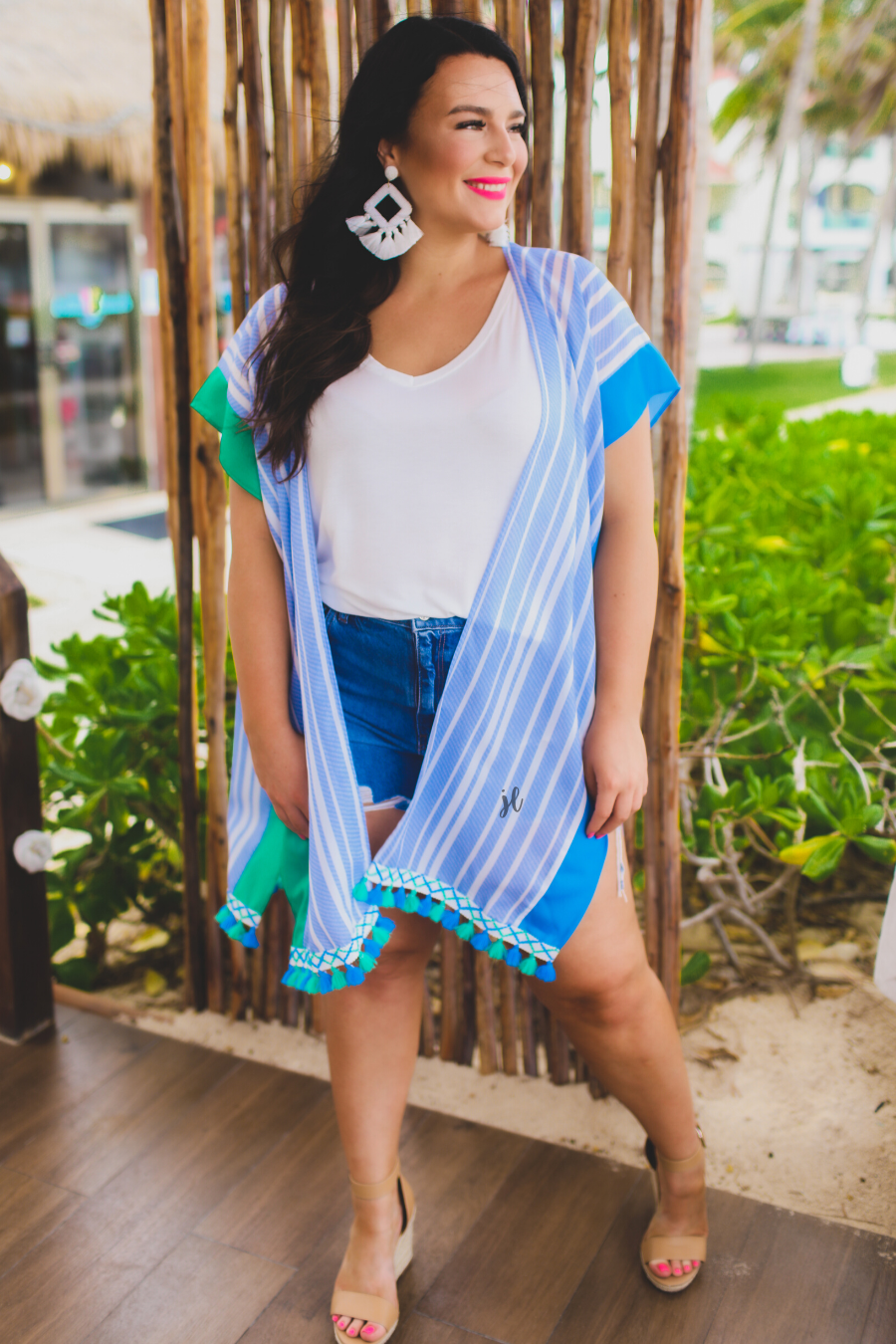 a loose-flowy fit kimono crafted from lightweight fabric with an open-front style, pom pom detailing, colored sides, and contrasting panels in blue