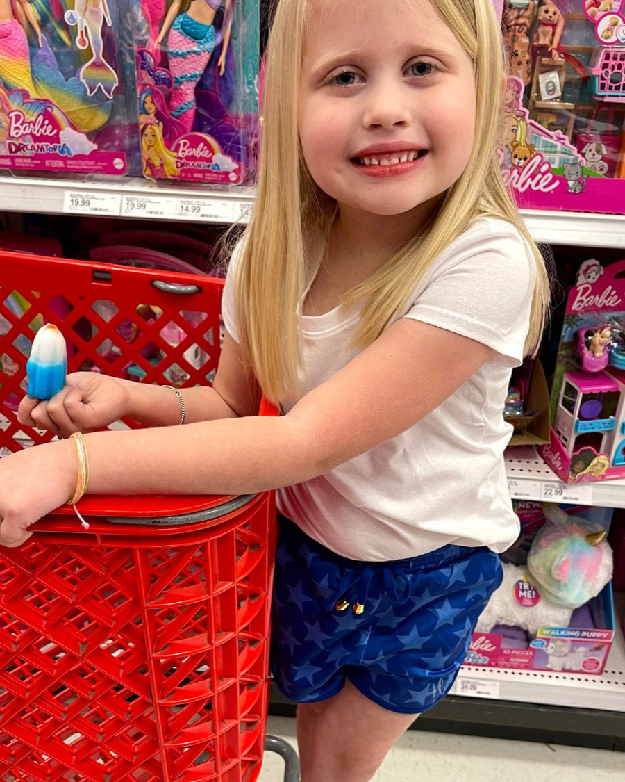 mid-rise relaxed fit activewear shorts with side pockets and a tie waist drawstring with gold bead accents, designed on a blue star-patterned print fabric, royal blue base, and royal blue trims