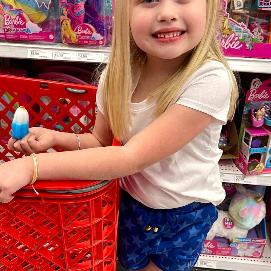 mid-rise relaxed fit activewear shorts with side pockets and a tie waist drawstring with gold bead accents, designed on a blue star-patterned print fabric, royal blue base, and royal blue trims