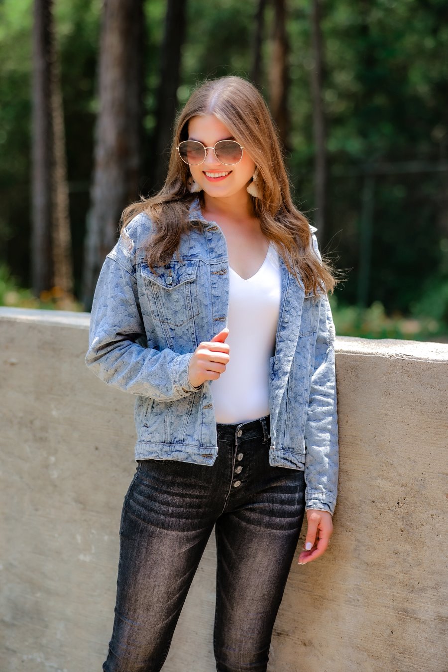 relaxed-fit jacket crafted from light wash denim with subtle distressing and faded leopard print accents, a button-down front, collared neckline, flap chest pockets, rollable long sleeves with buttoned cuffs, and a straight hemline