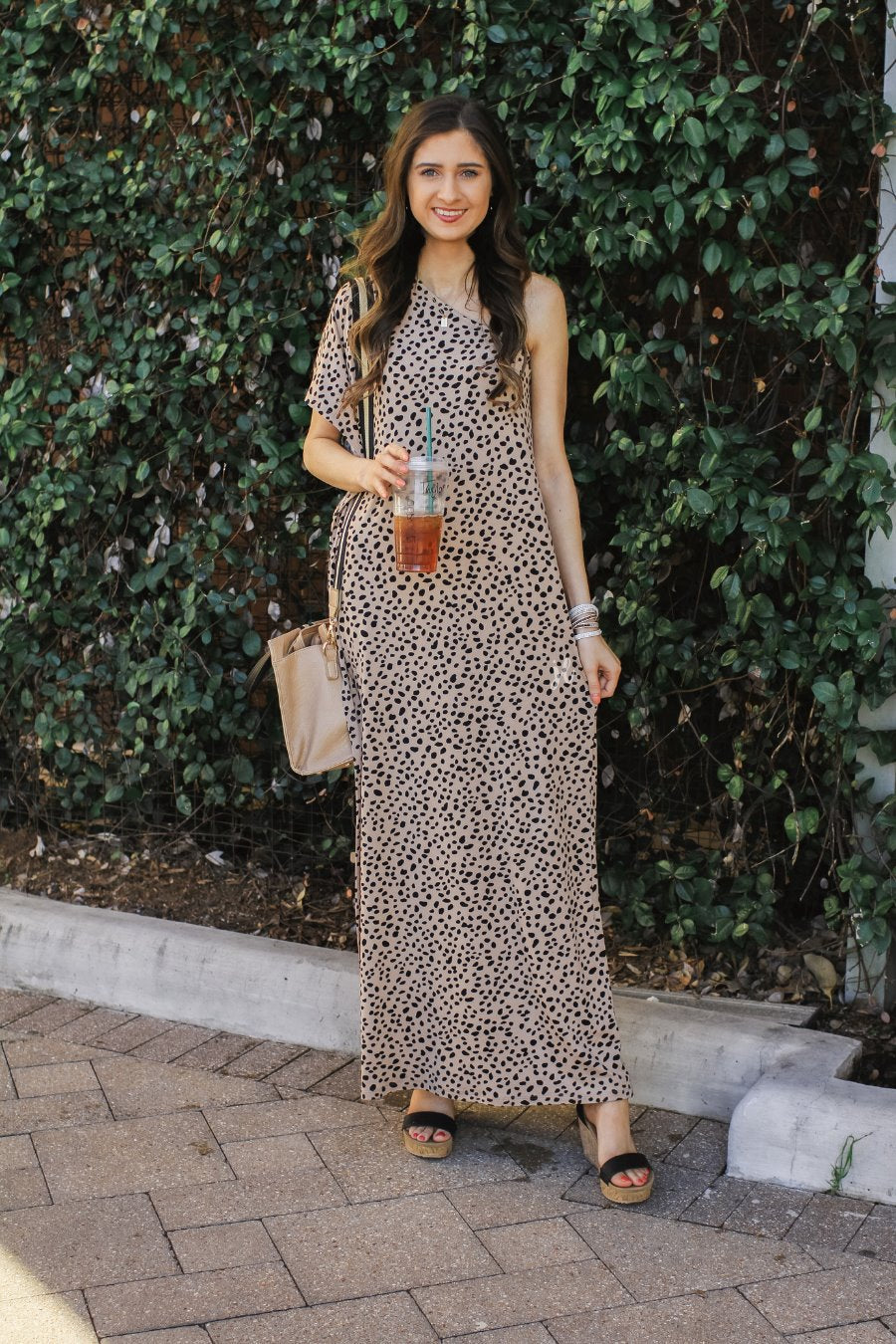 a maxi dress with a trendy one-shoulder neckline, a relaxed short sleeve, functional side pockets, subtle side slits, and square hemline on a black leopard pattern and taupe base