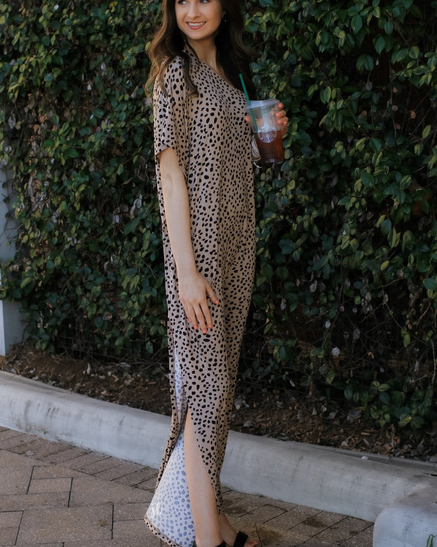 a maxi dress with a trendy one-shoulder neckline, a relaxed short sleeve, functional side pockets, subtle side slits, and square hemline on a black leopard pattern and taupe base