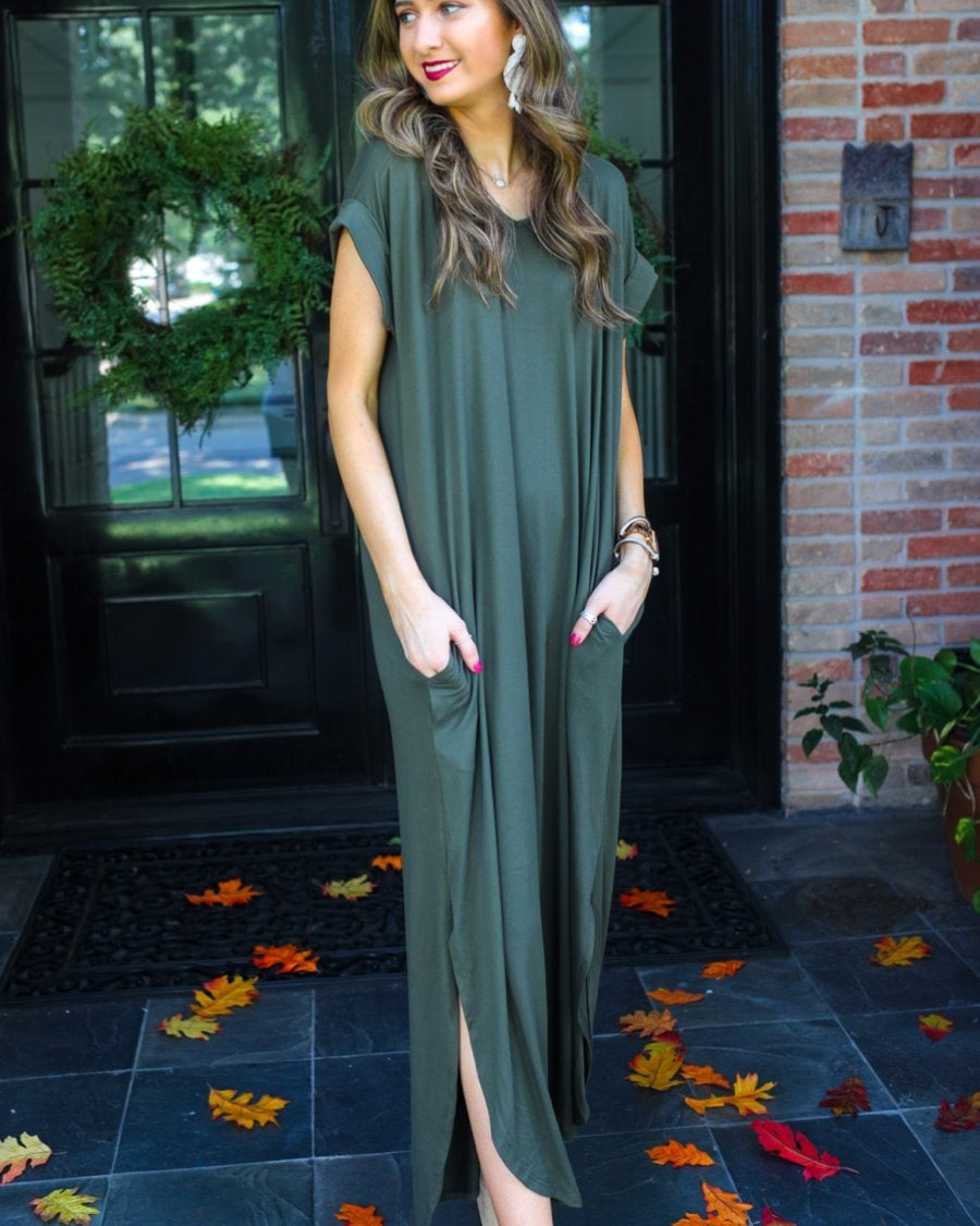 oversized short-sleeve t-shirt dress crafted from soft, stretchy material with a V-neckline, cuffed sleeves, side slits, and pockets on a solid olive fabric