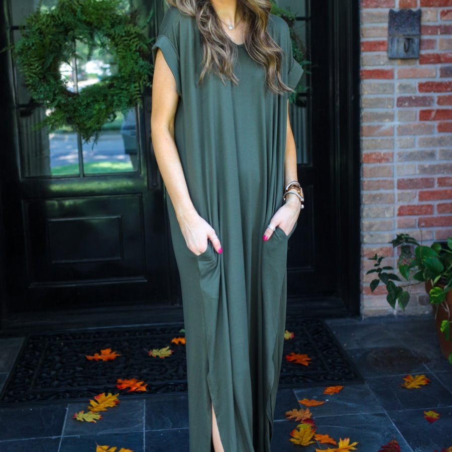 oversized short-sleeve t-shirt dress crafted from soft, stretchy material with a V-neckline, cuffed sleeves, side slits, and pockets on a solid olive fabric