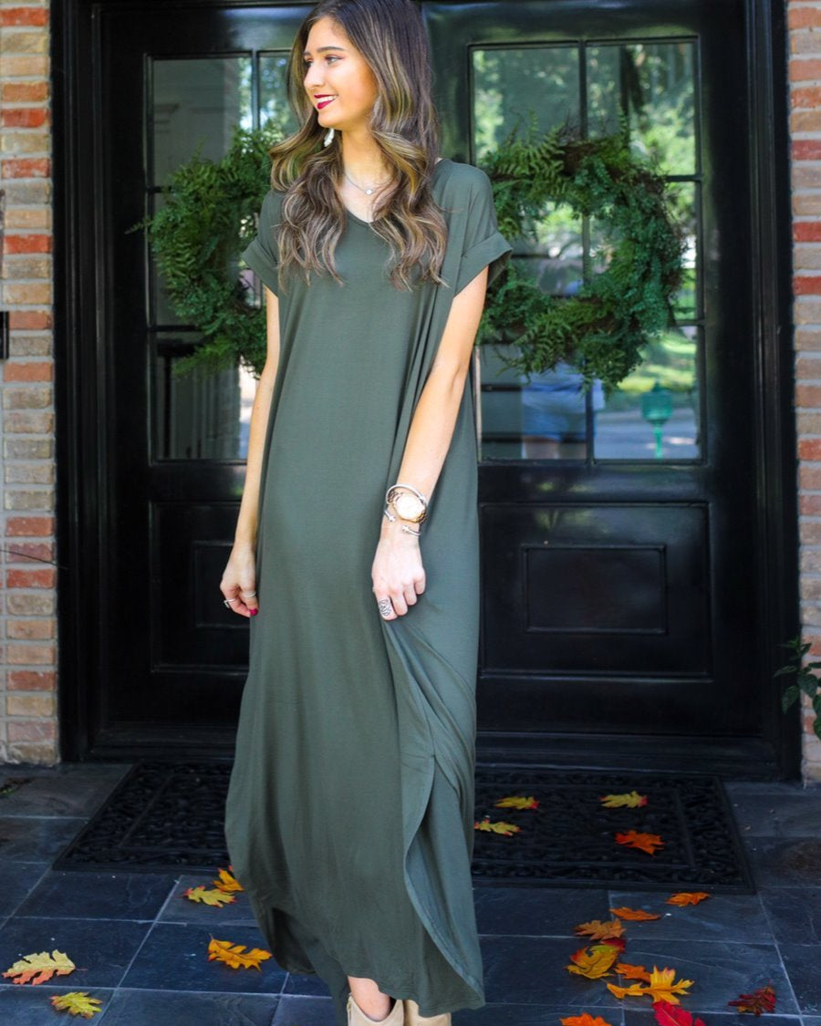 oversized short-sleeve t-shirt dress crafted from soft, stretchy material with a V-neckline, cuffed sleeves, side slits, and pockets on a solid olive fabric