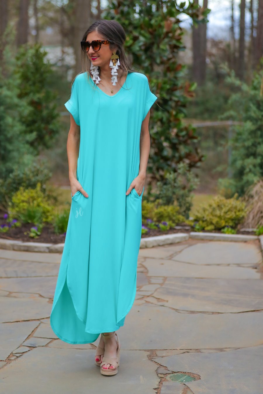 oversized short-sleeve t-shirt dress crafted from soft, stretchy material with a V-neckline, cuffed sleeves, side slits, and pockets on a solid mint fabric