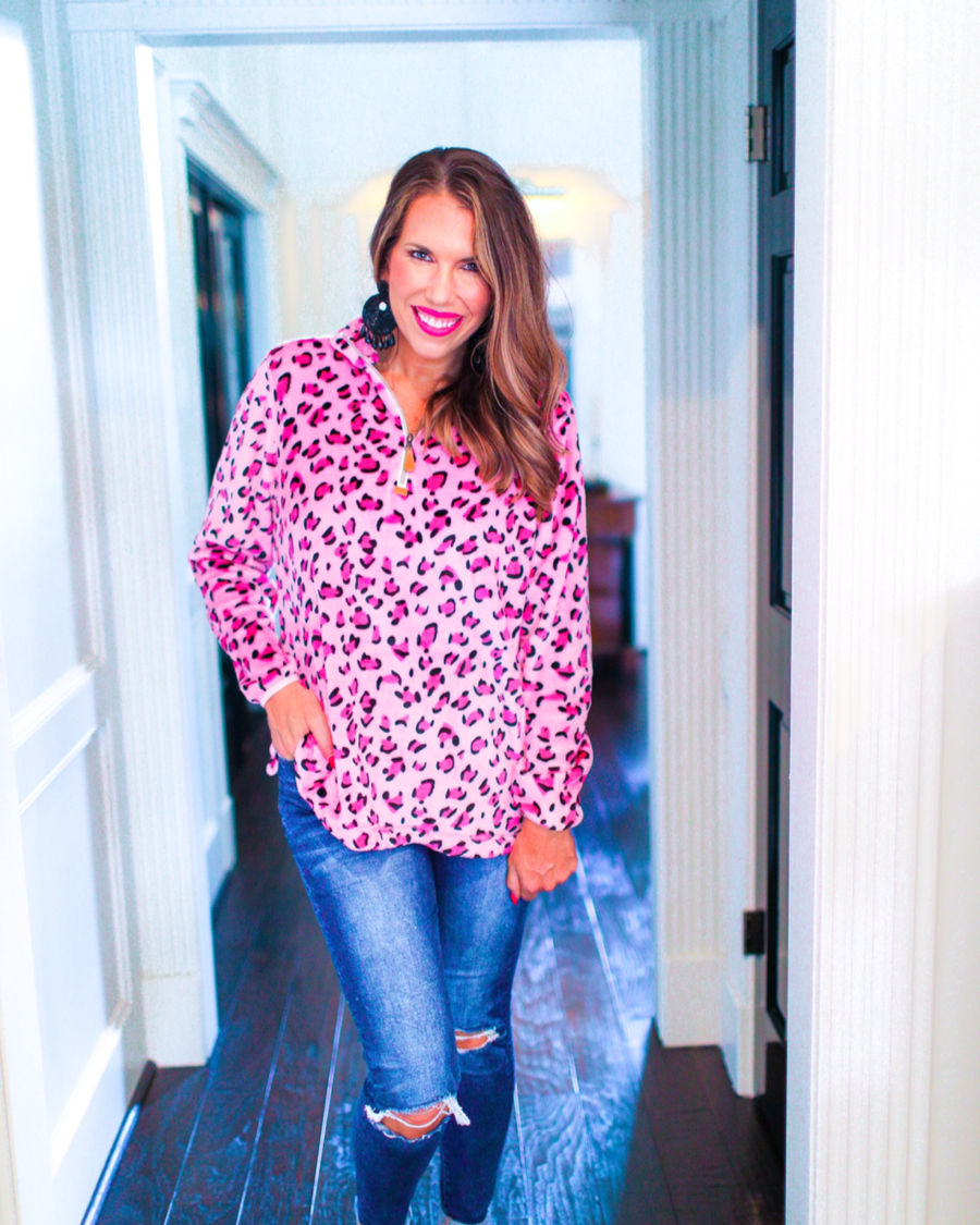 long sleeve pullover with a quarter zip, a foldable collar, and a split hemline crafted on a ultra soft pink leopard fabric