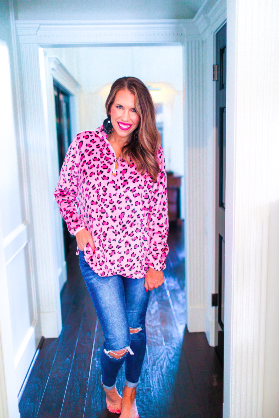 long sleeve pullover with a quarter zip, a foldable collar, and a split hemline crafted on a ultra soft pink leopard fabric