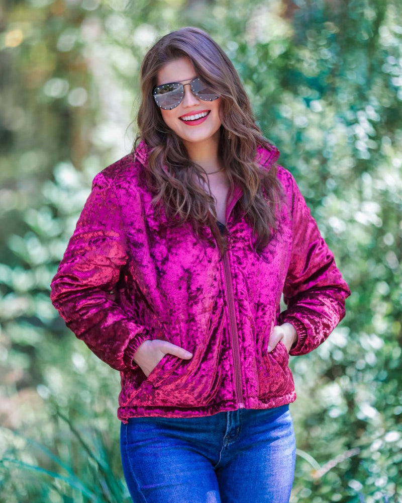 long-sleeve zip front closure jacket with a collar, side pockets, and adjustable drawstring hems made of lightweight material in wine color