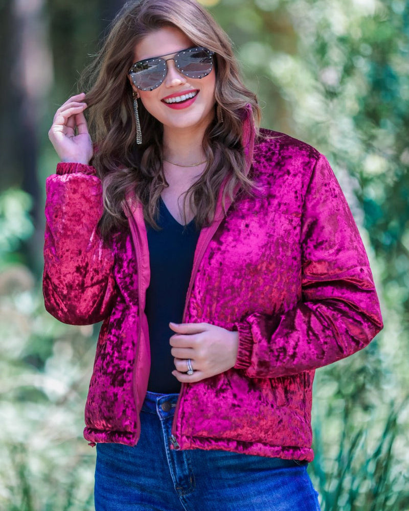 long-sleeve zip front closure jacket with a collar, side pockets, and adjustable drawstring hems made of lightweight material in wine color