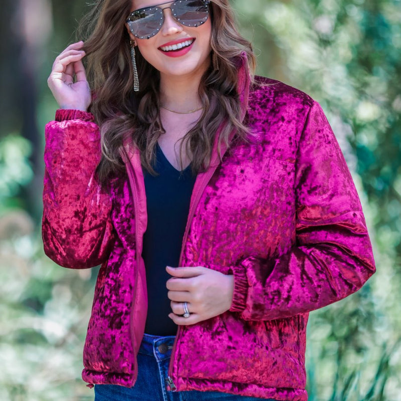 long-sleeve zip front closure jacket with a collar, side pockets, and adjustable drawstring hems made of lightweight material in wine color