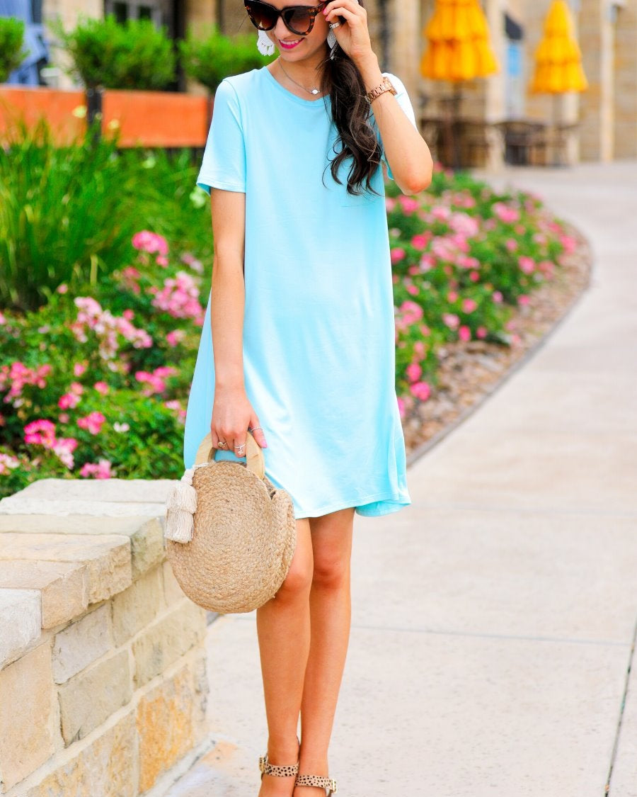 short sleeves made of super soft fabric with a round neckline, A-line style with a straight hemline, and a front chest pocket in aqua