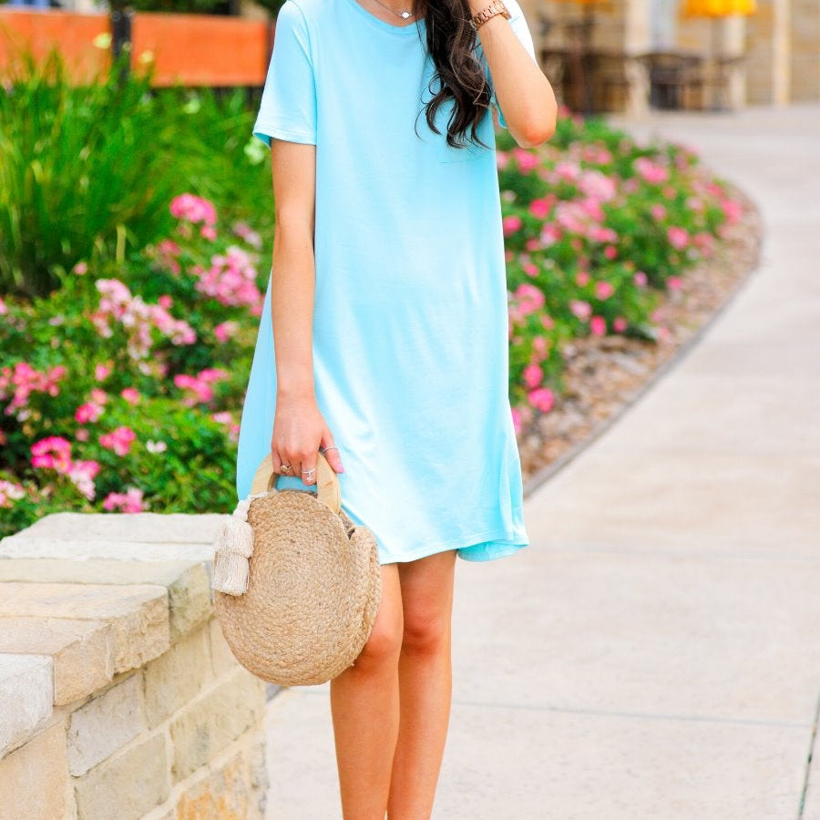 short sleeves made of super soft fabric with a round neckline, A-line style with a straight hemline, and a front chest pocket in aqua