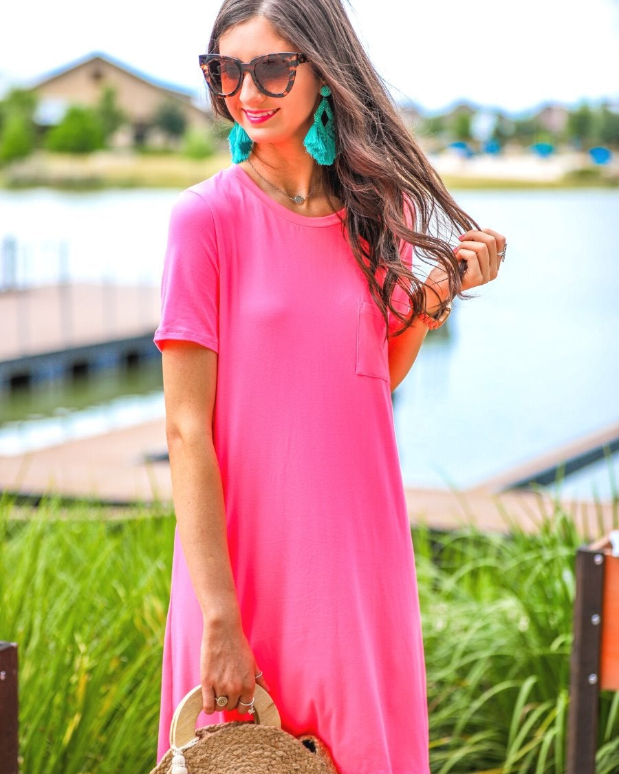 short sleeves made of super soft fabric with a round neckline, A-line style with a straight hemline, and a front chest pocket in neon pink