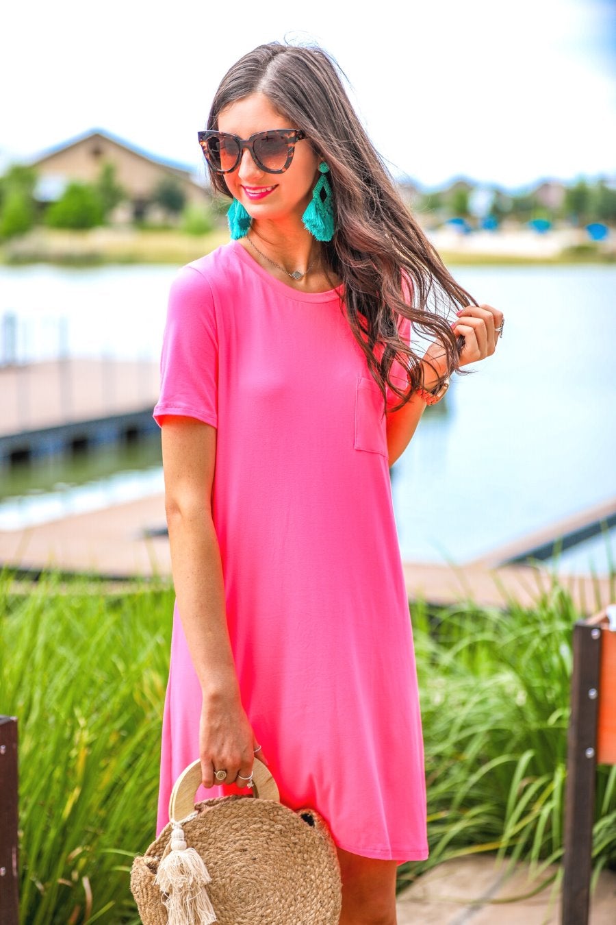 short sleeves made of super soft fabric with a round neckline, A-line style with a straight hemline, and a front chest pocket in neon pink
