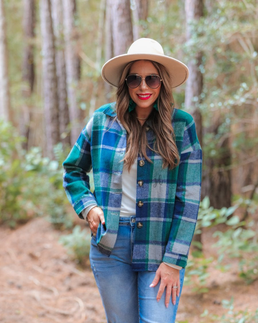 long sleeve shacket with fitted button closure cuffs, a button-down front, and a collared neckline on a green plaid print