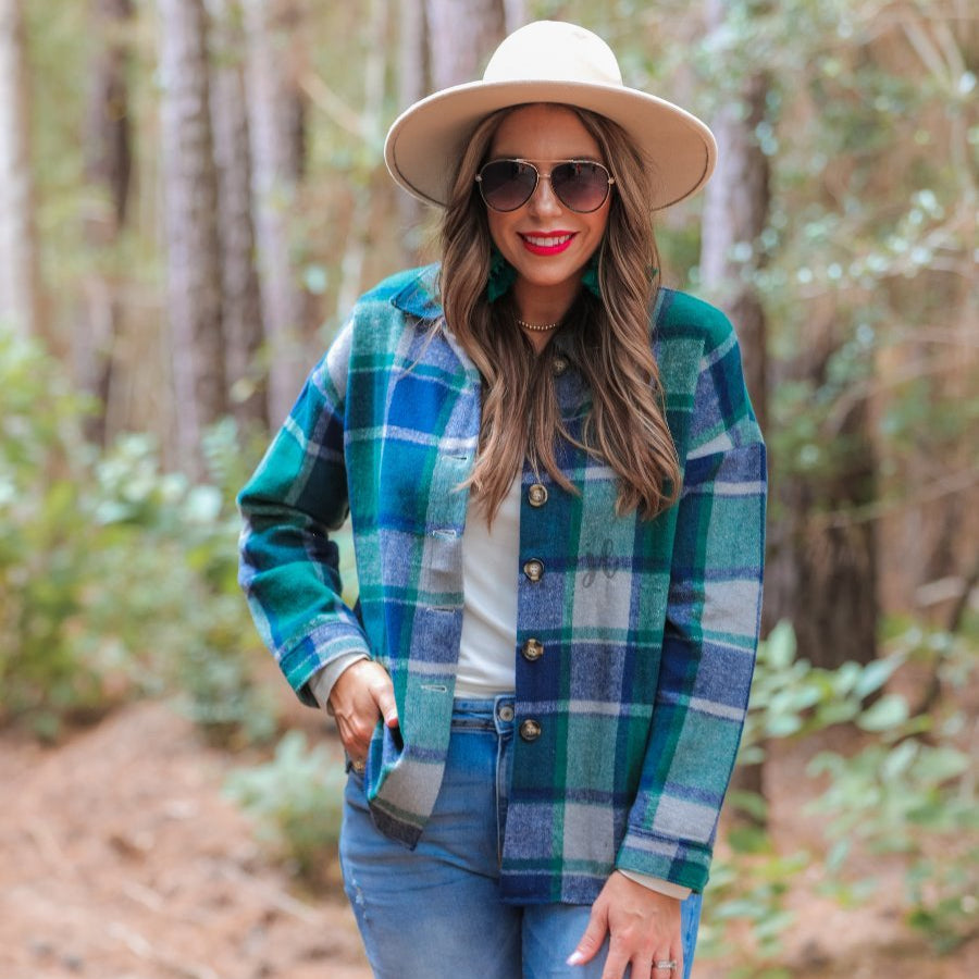 long sleeve shacket with fitted button closure cuffs, a button-down front, and a collared neckline on a green plaid print