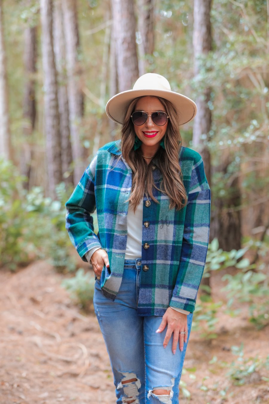 long sleeve shacket with fitted button closure cuffs, a button-down front, and a collared neckline on a green plaid print