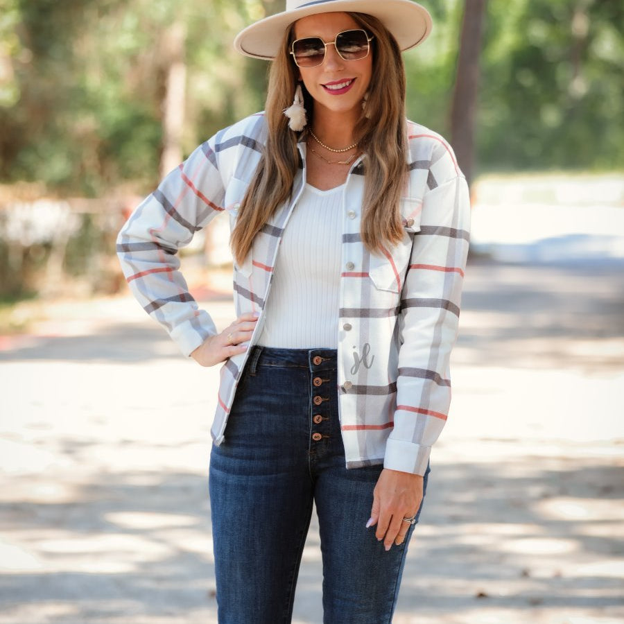 long sleeve shacket with fitted button closure cuffs, a button-down front, and a collared neckline on an ivory plaid print