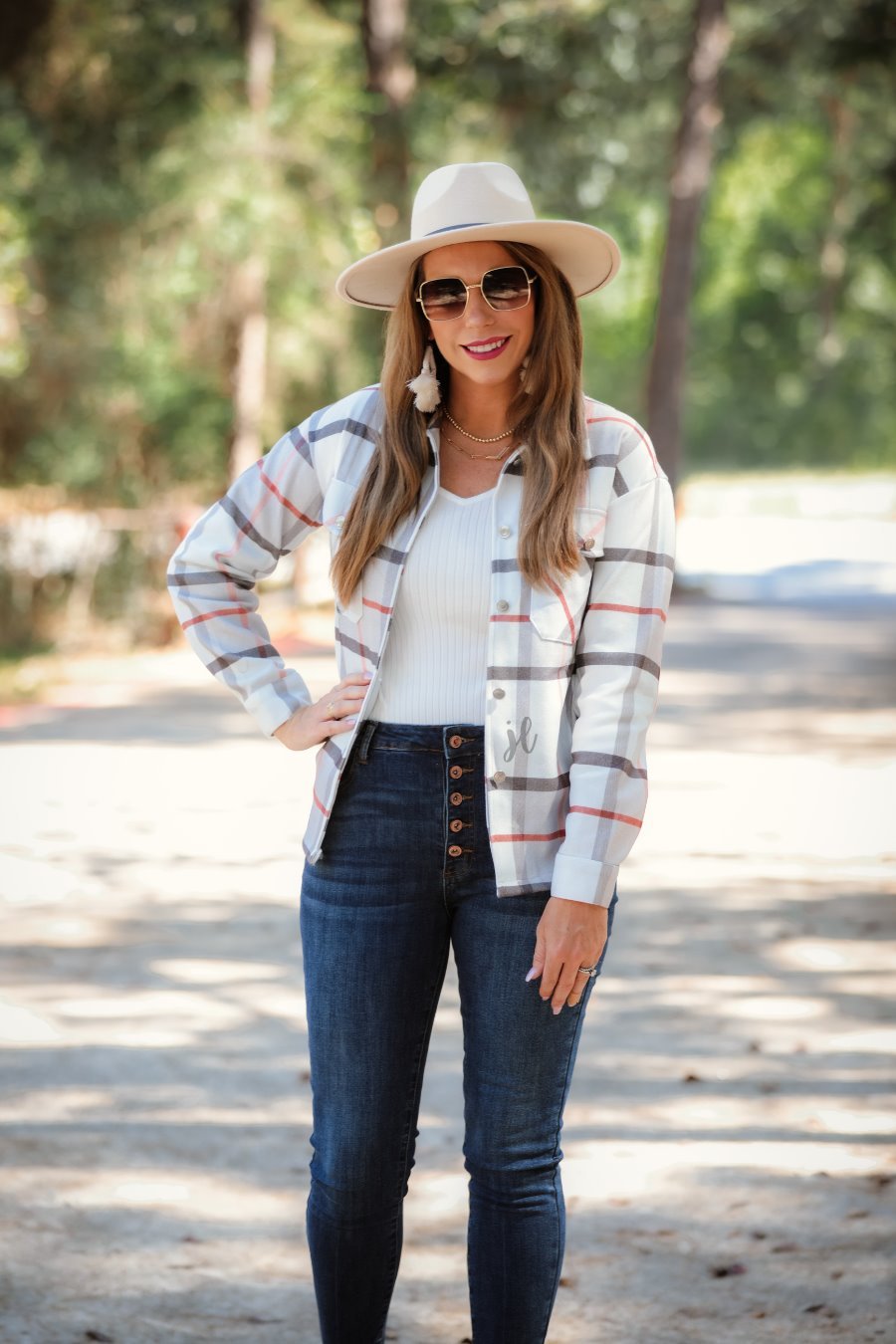 long sleeve shacket with fitted button closure cuffs, a button-down front, and a collared neckline on an ivory plaid print