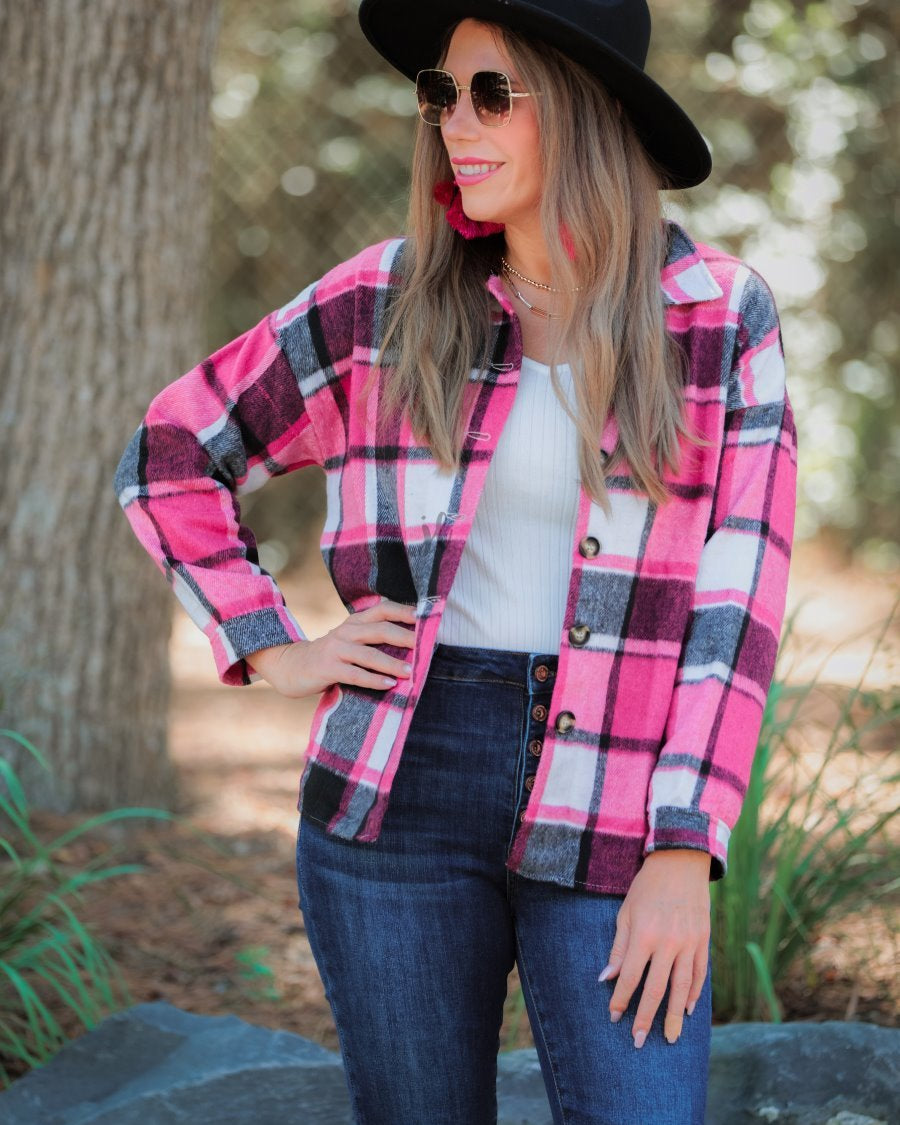 long sleeve shacket with fitted button closure cuffs, a button-down front, and a collared neckline on a pink plaid print