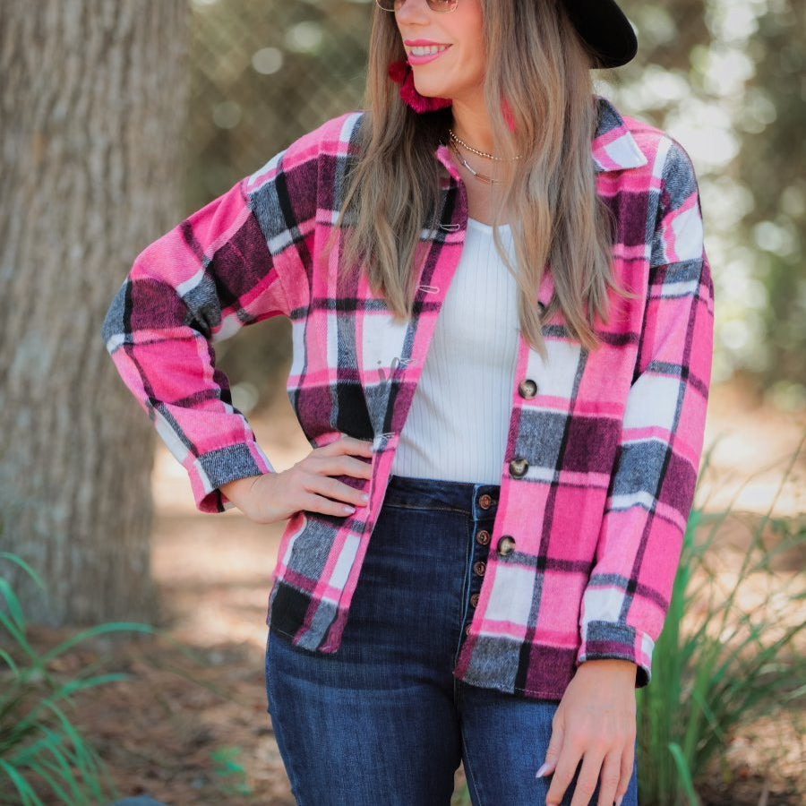 long sleeve shacket with fitted button closure cuffs, a button-down front, and a collared neckline on a pink plaid print