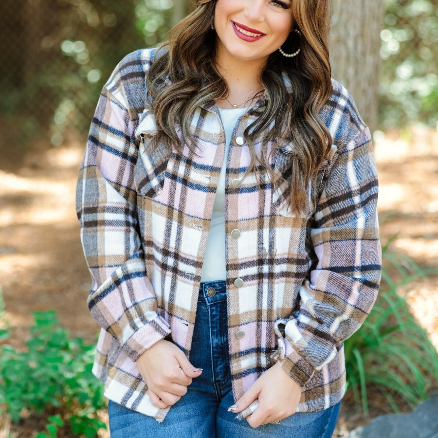 long sleeve shacket with fitted button closure cuffs, a button-down front, and a collared neckline on a tan plaid print