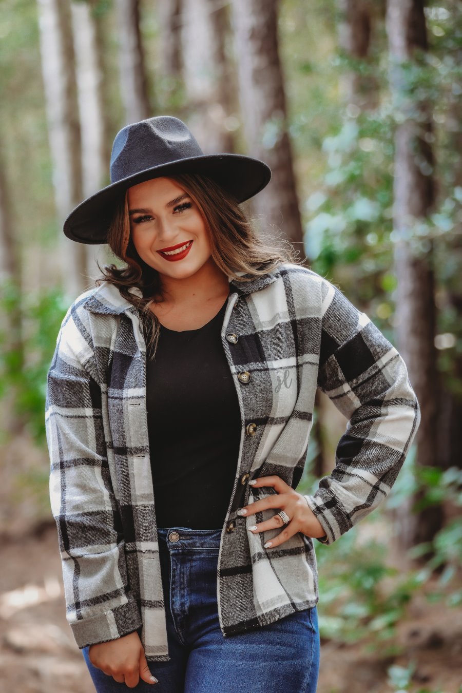 long sleeve shacket with fitted button closure cuffs, a button-down front, and a collared neckline on a black plaid print