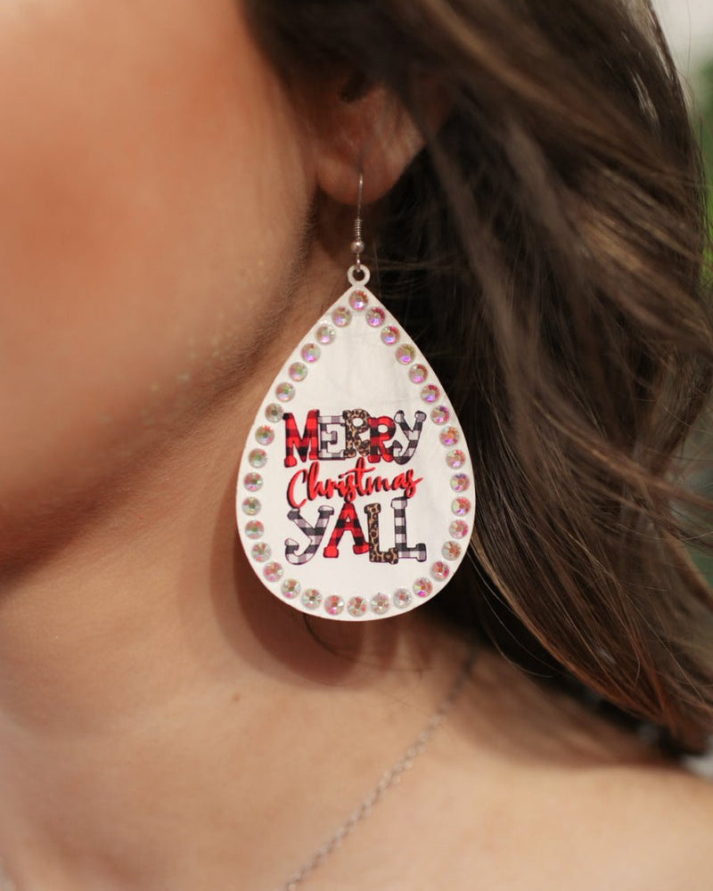 a fish hook back teardrop shape earring with a rhinestone outline and 'MERRY CHRISTMAS Y'ALL' written in alternating prints of red/black checkered, black/white checkered, brown leopard, and solid red