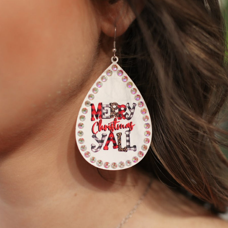 a fish hook back teardrop shape earring with a rhinestone outline and 'MERRY CHRISTMAS Y'ALL' written in alternating prints of red/black checkered, black/white checkered, brown leopard, and solid red