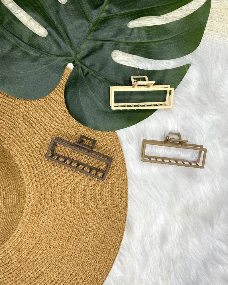 a metal neutral rectangular claw clip with a secure hold that reduces breakage in brown, peach, and tan