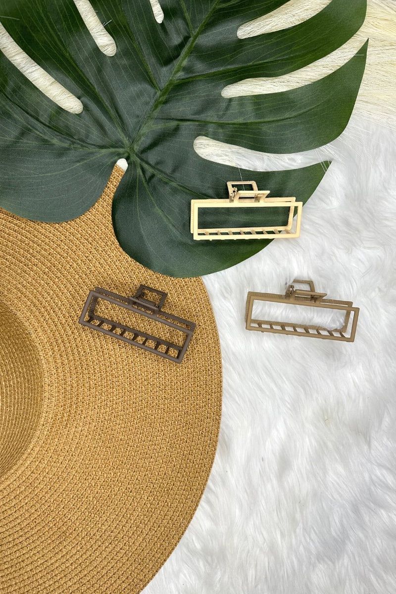 a metal neutral rectangular claw clip with a secure hold that reduces breakage in brown, peach, and tan