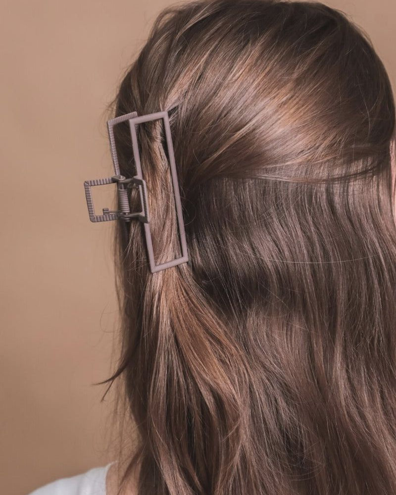 a metal neutral rectangular claw clip with a secure hold that reduces breakage in brown