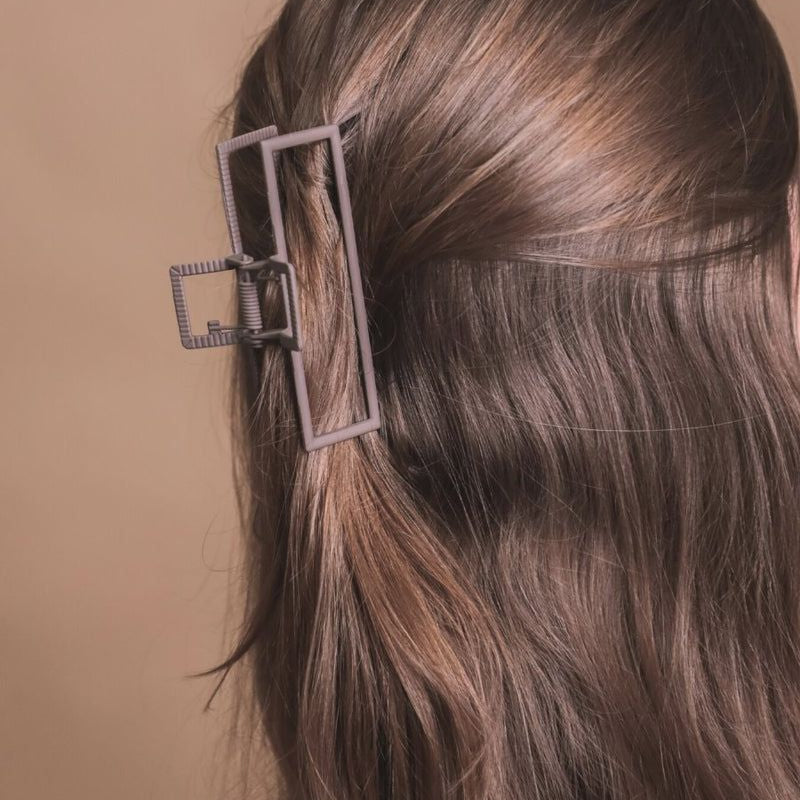 a metal neutral rectangular claw clip with a secure hold that reduces breakage in brown