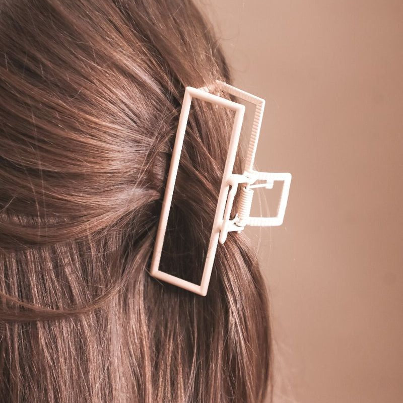 a metal neutral rectangular claw clip with a secure hold that reduces breakage in peach
