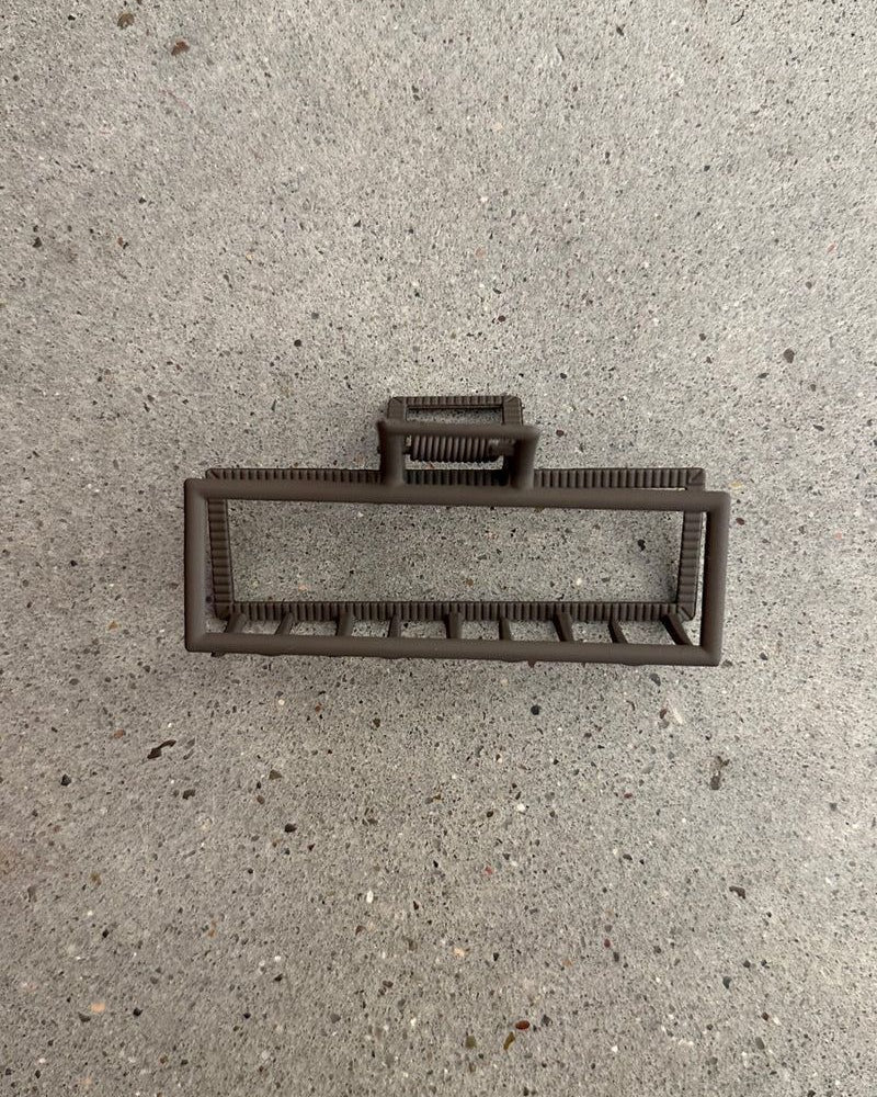 a metal neutral rectangular claw clip with a secure hold that reduces breakage in brown