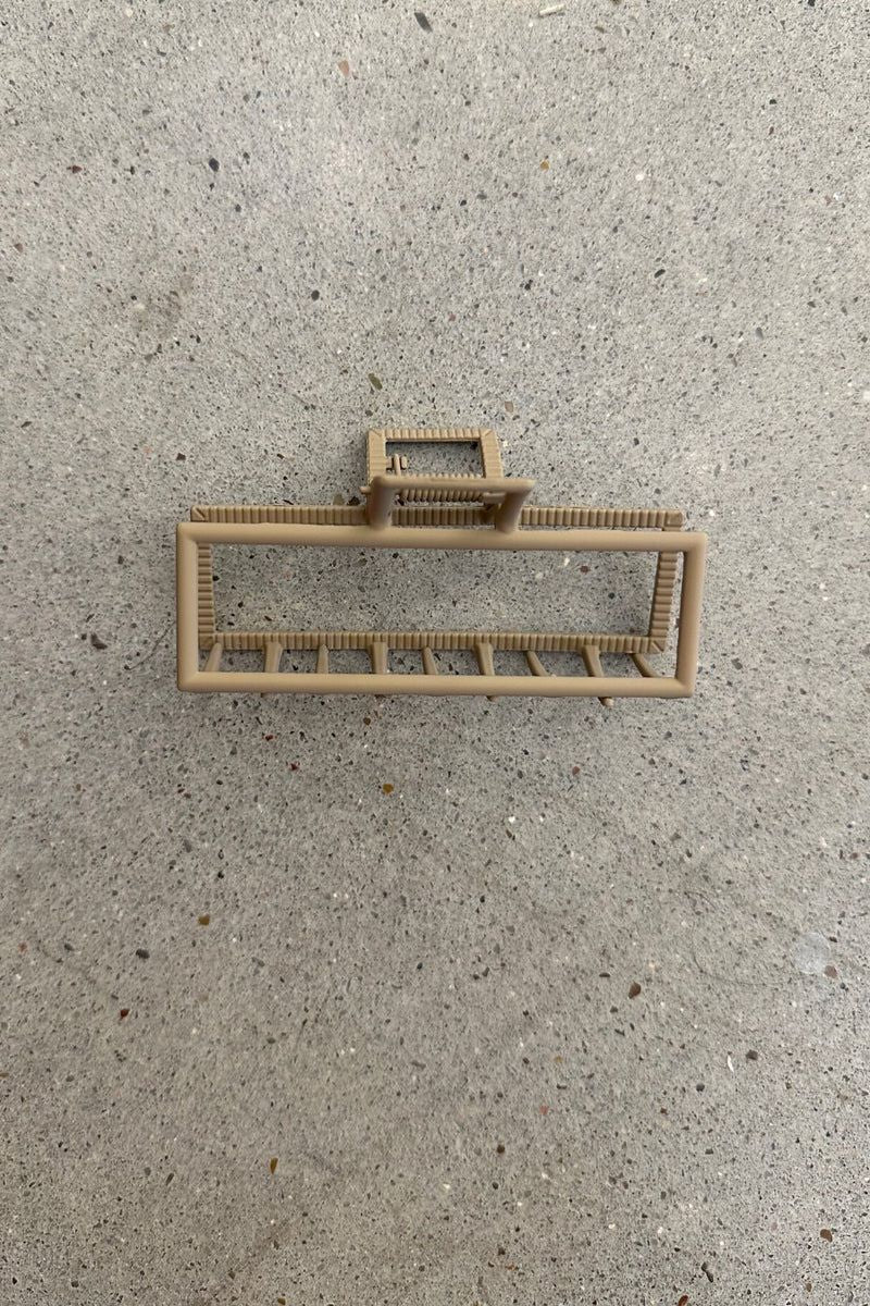 a metal neutral rectangular claw clip with a secure hold that reduces breakage in tan