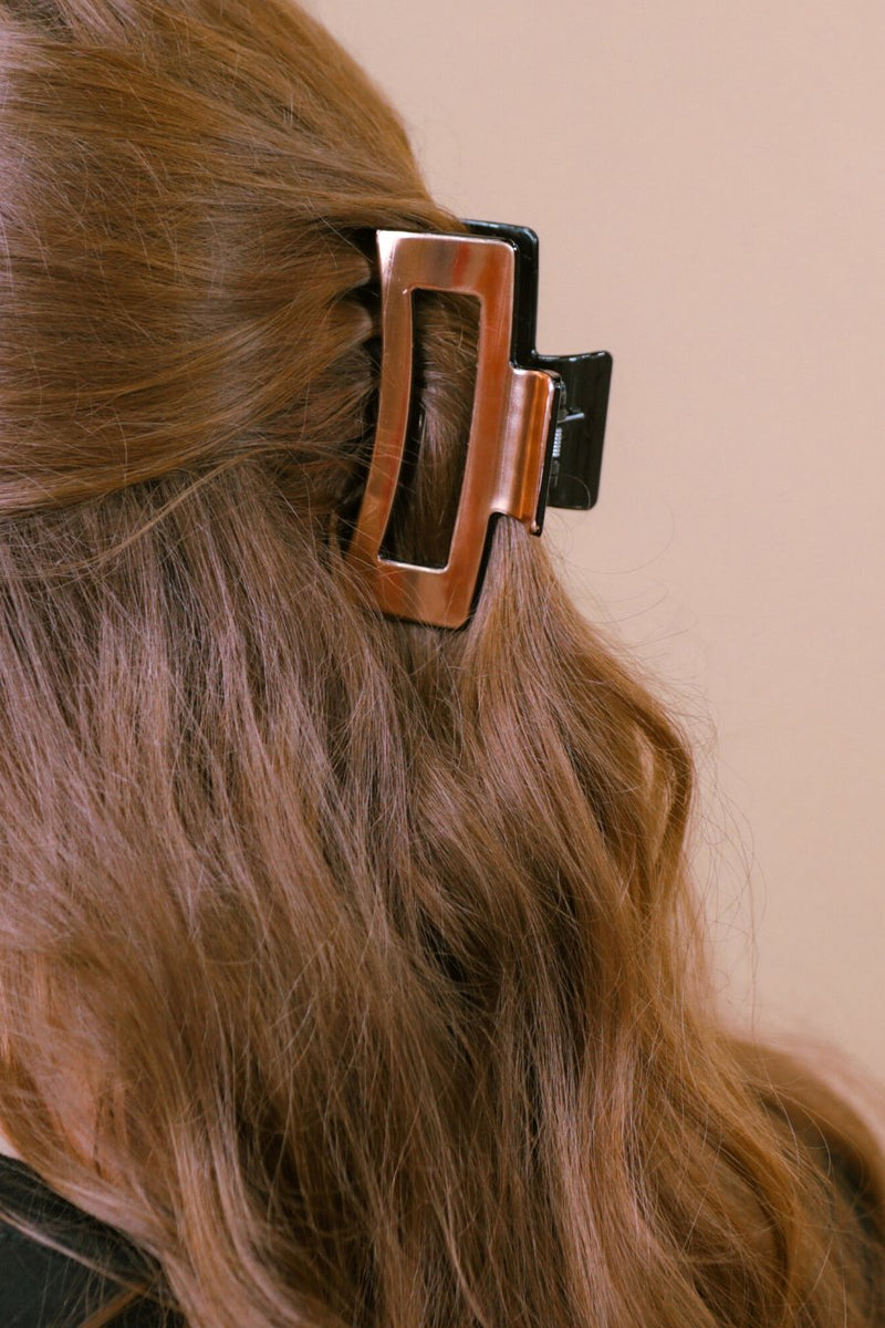 a metallic claw clip with a strong hold and sleek shine in rose gold