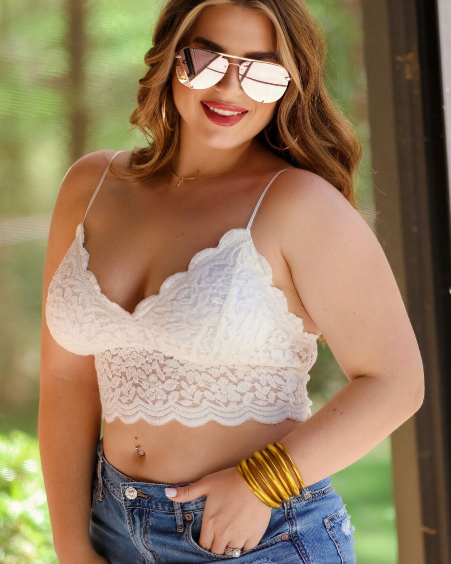 crochet lace bralette with a pullover style, a V-neckline, adjustable straps, and removable pads in ivory