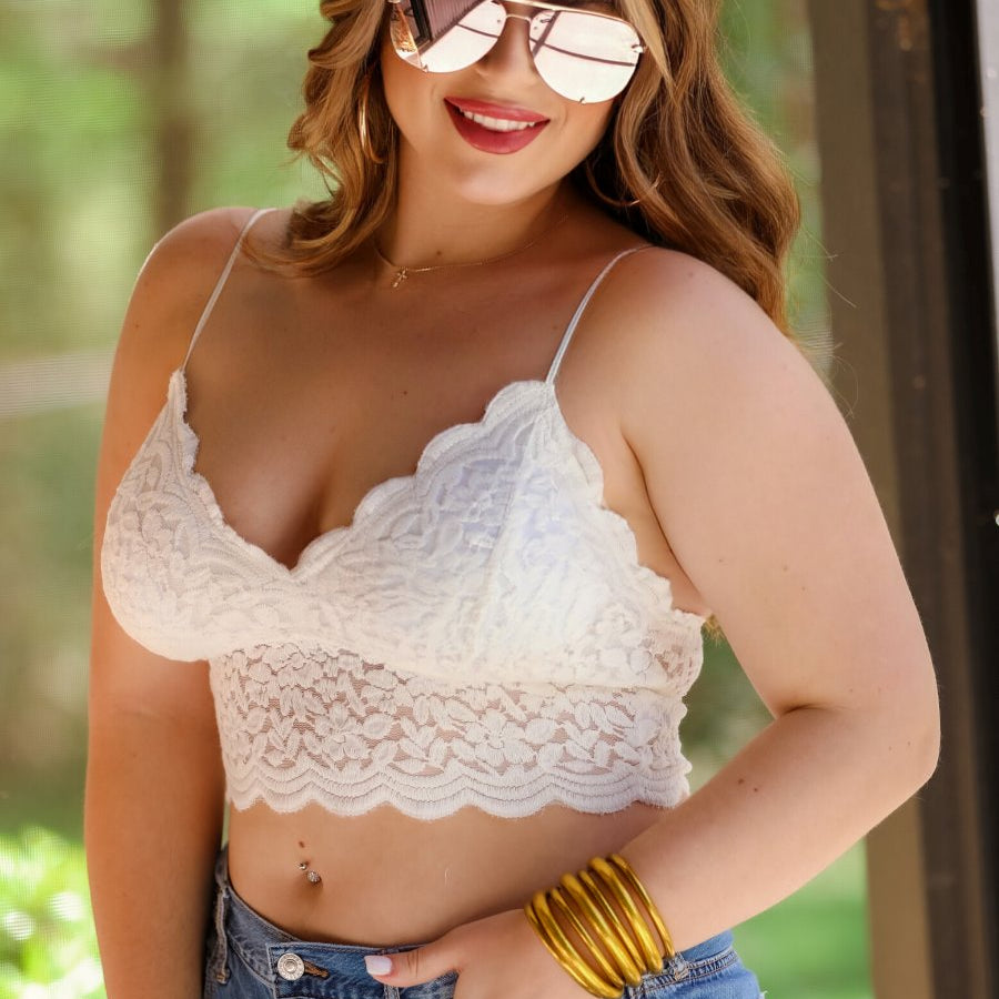 crochet lace bralette with a pullover style, a V-neckline, adjustable straps, and removable pads in ivory