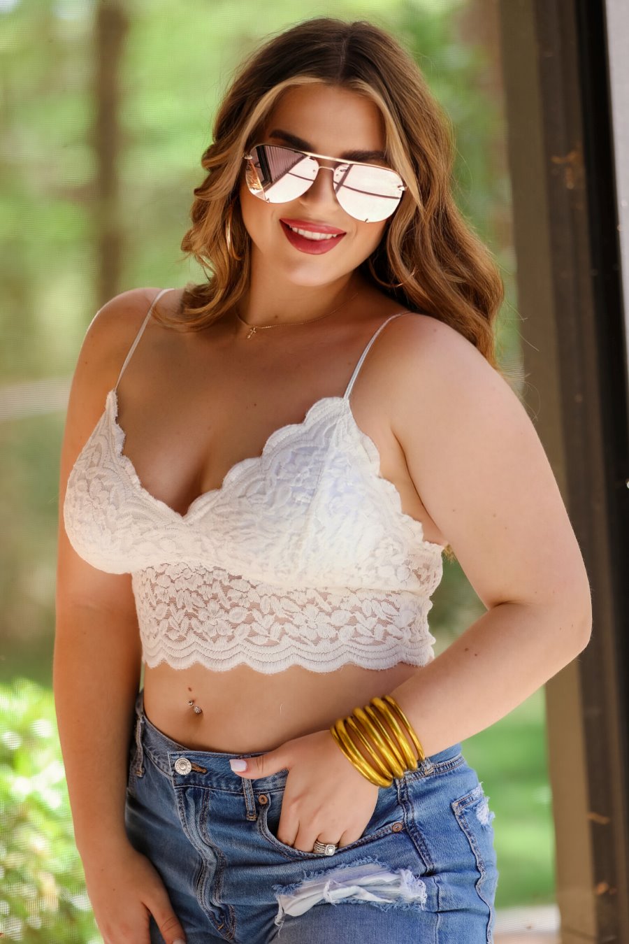 crochet lace bralette with a pullover style, a V-neckline, adjustable straps, and removable pads in ivory