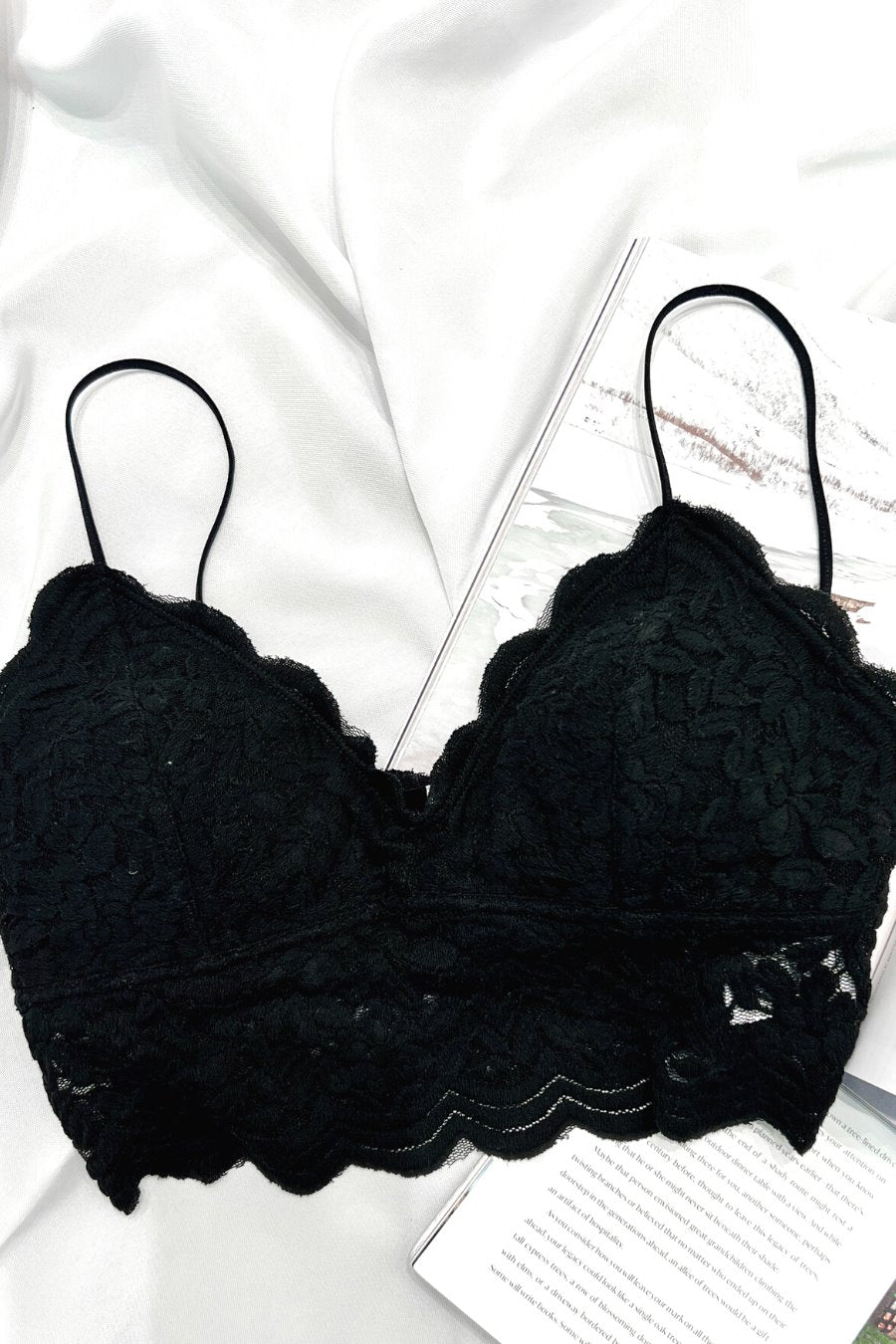 crochet lace bralette with a pullover style, a V-neckline, adjustable straps, and removable pads in black