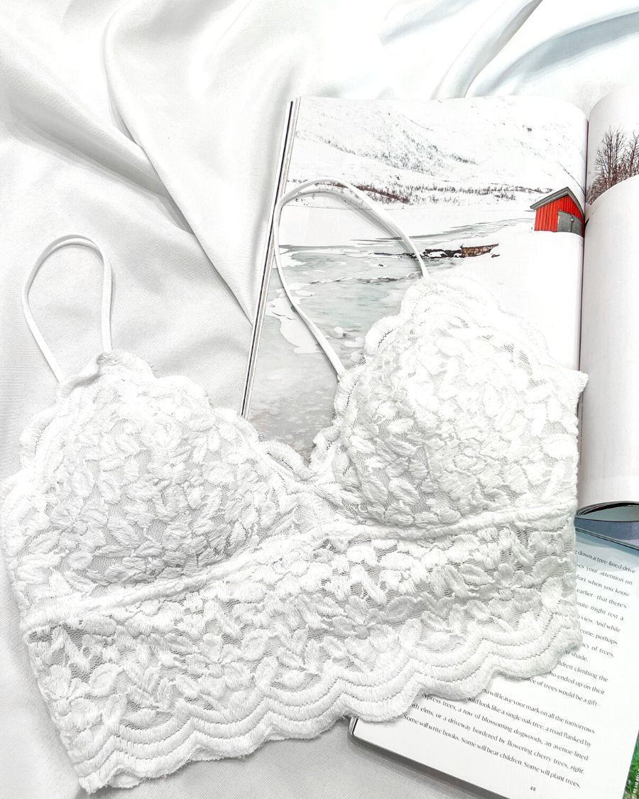 crochet lace bralette with a pullover style, a V-neckline, adjustable straps, and removable pads in ivory
