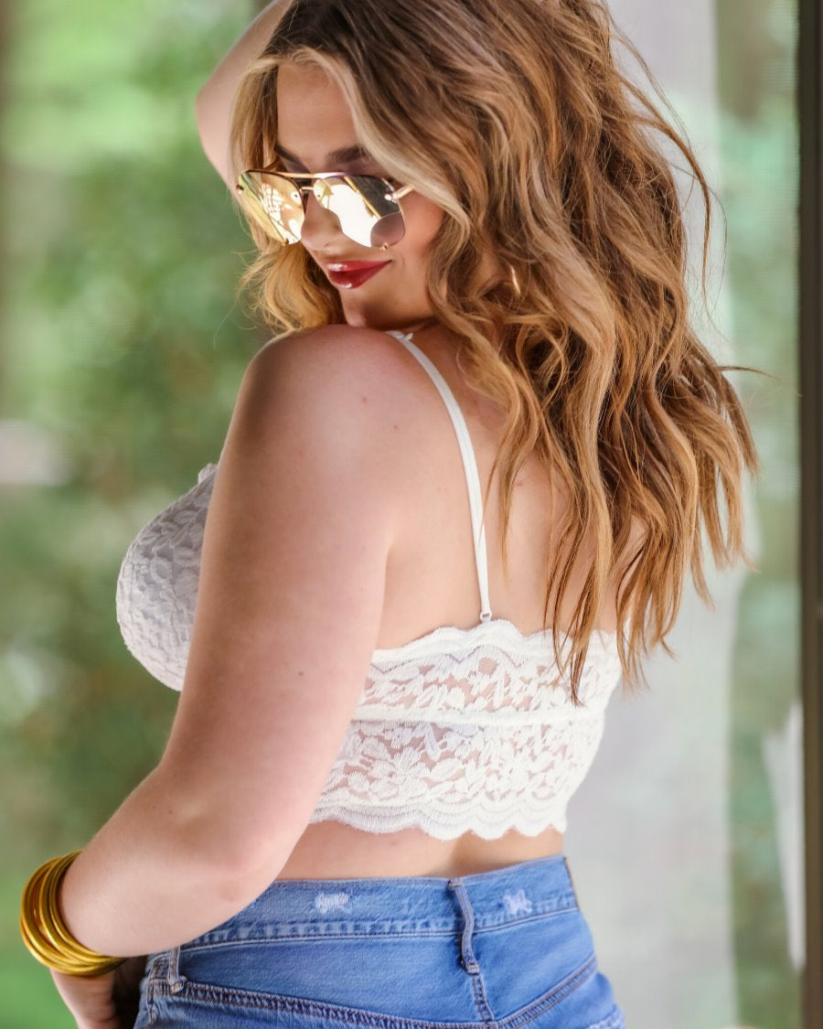 crochet lace bralette with a pullover style, a V-neckline, adjustable straps, and removable pads in ivory