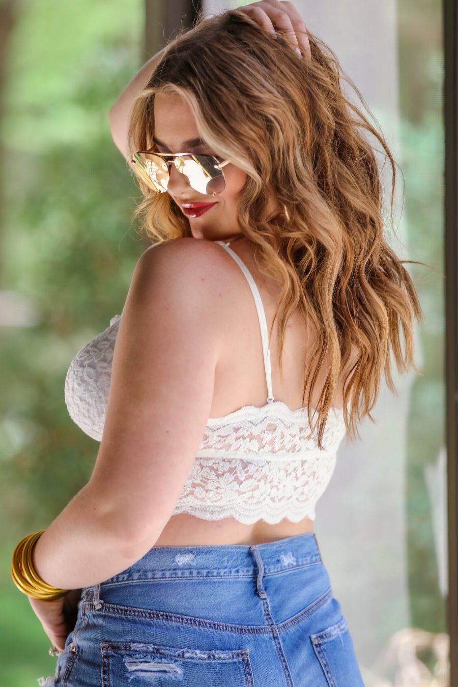 crochet lace bralette with a pullover style, a V-neckline, adjustable straps, and removable pads in ivory