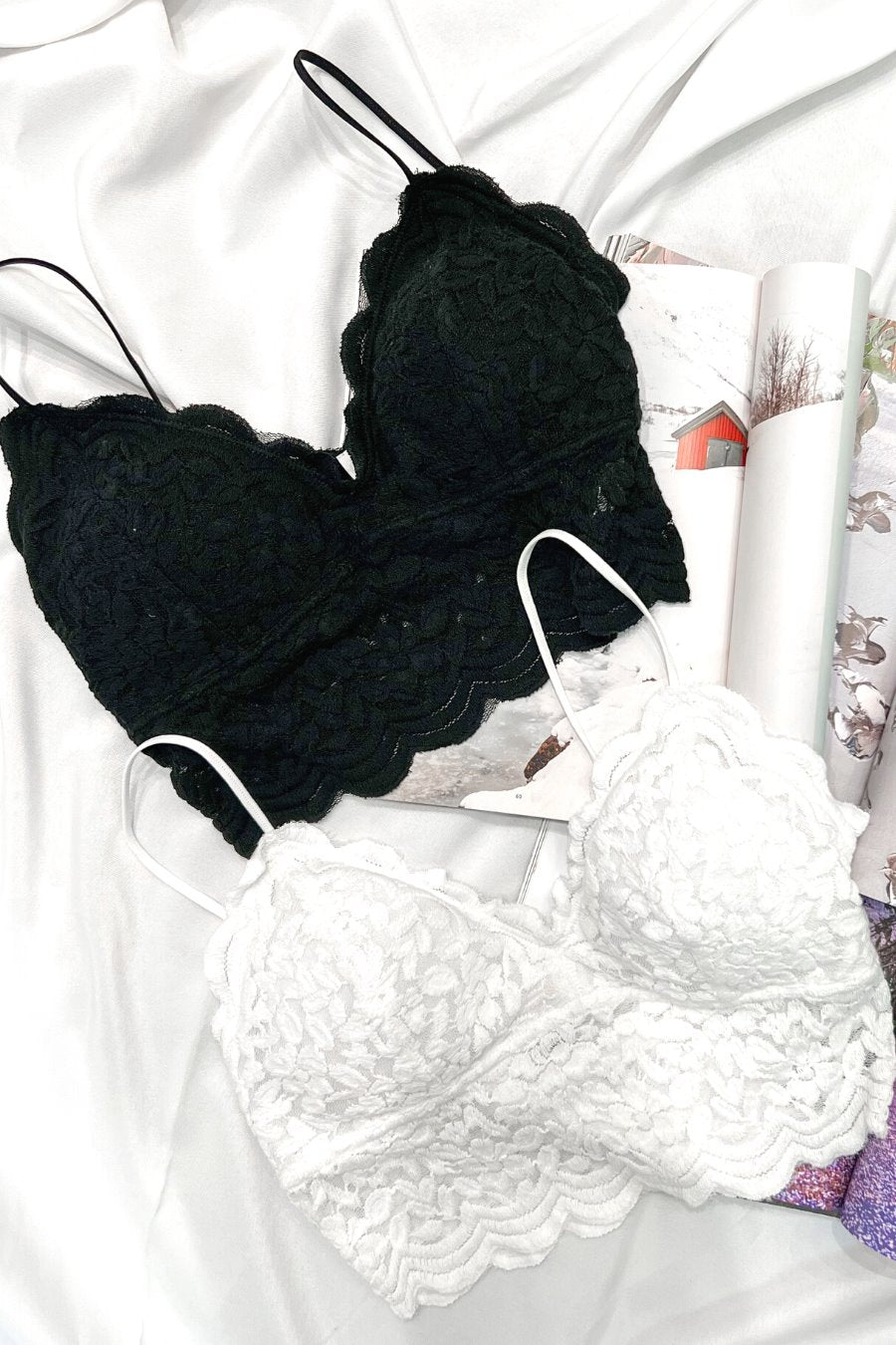 crochet lace bralette with a pullover style, a V-neckline, adjustable straps, and removable pads in black and ivory