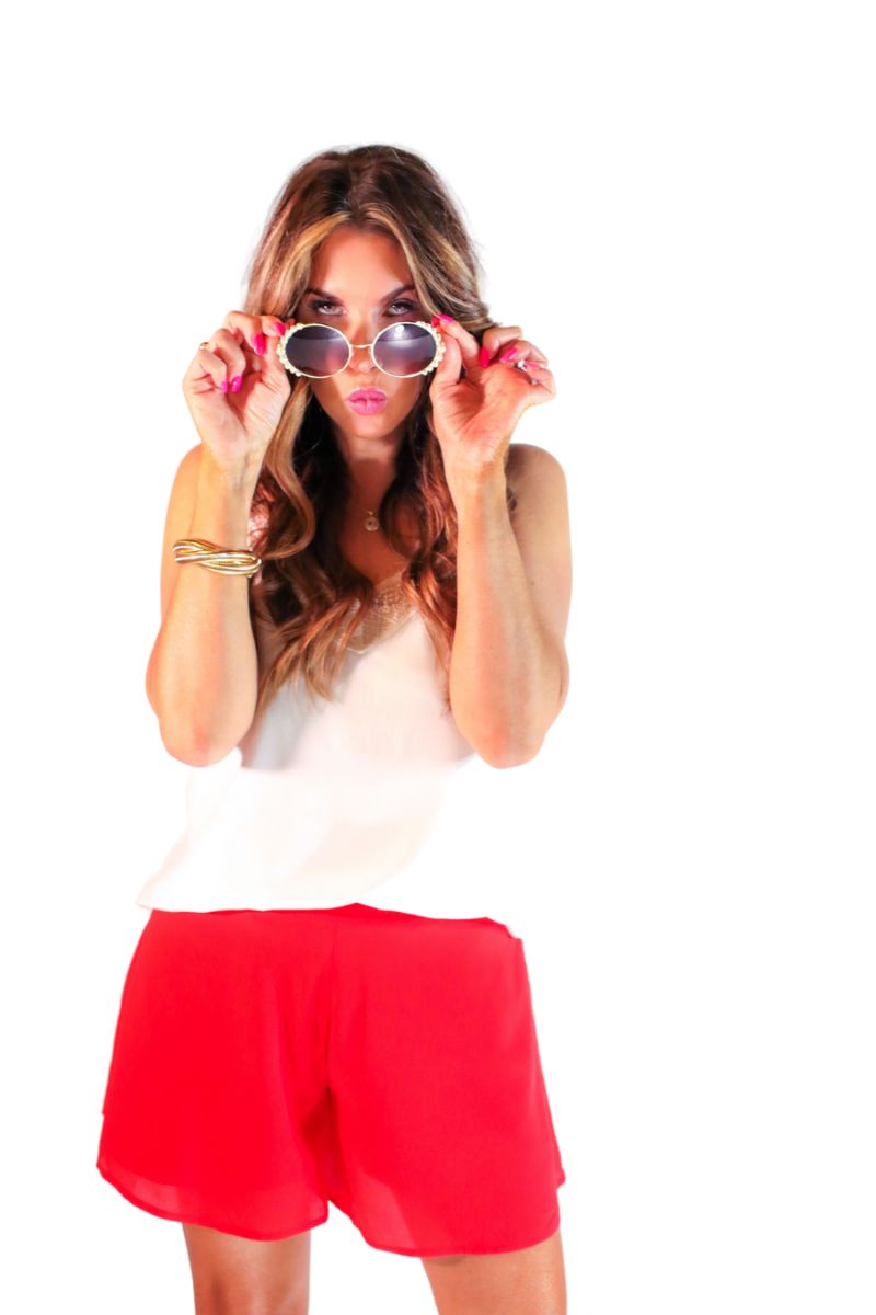 red swing shorts with a relaxed fit, an elastic waistband, pocket-free design, breezy drape, and a skirt-inspired silhouette