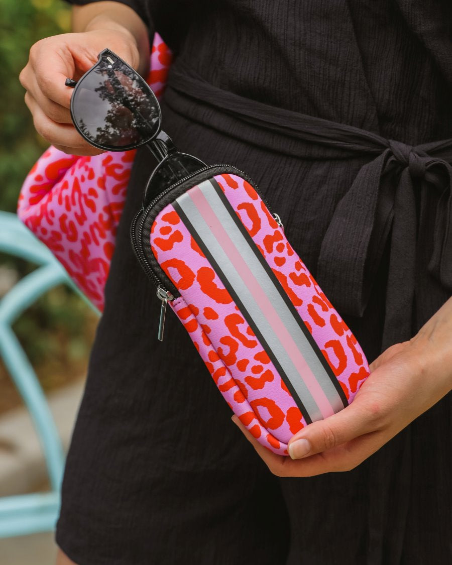 ultra-lightweight sunglasses case made of neoprene with a top double zipper in silver hardware and corresponding racing stripes in pink leopard